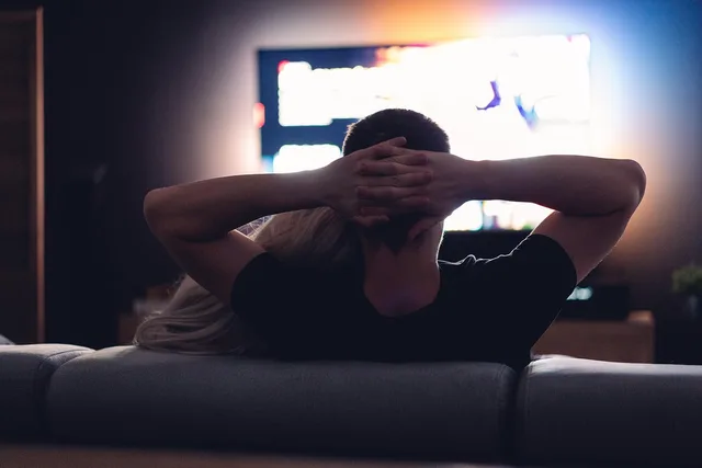 couple, dark room, watching, together, tv, television, girl, guy, man, woman, room, screen, entertainment, recreation, movies, series. Connected TV advertising: a UK ad fraud checklist