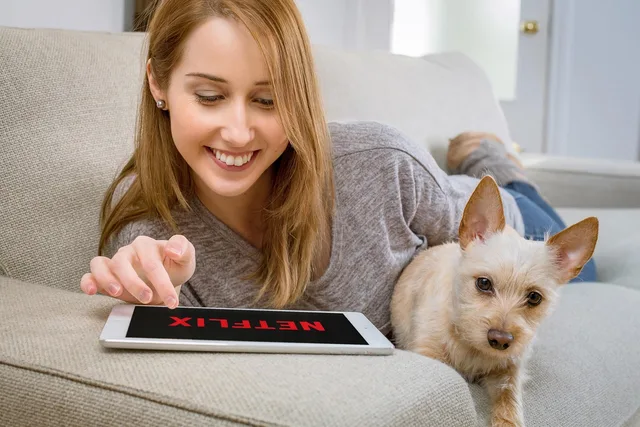 woman, dog, netflix, tablet, streaming, video, movies, home, pet, animal, couch, leisure. Connected TV channel strategy: routes, targeting and consent