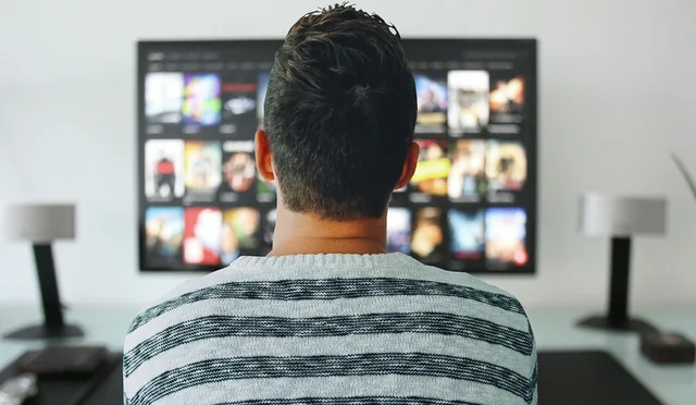 new year, man, tv, watching, room, office, modern, technology, screen, watching control, home, desk, table, concept, video, netflix, entertainment, media, digital, film, presentation, play, network, searches, episode, movies. Cross-border connected TV campaigns between the UK, Ireland and the EU