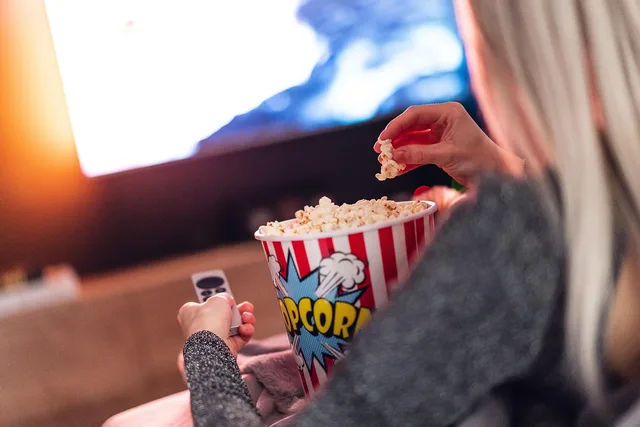 popcorn, girl, food, eating, watching, woman, female, tv, television, snack, entertainment, movie, closeup, popcorn, popcorn, popcorn, popcorn, popcorn. Check the connected TV advertising hidden costs in your media plan